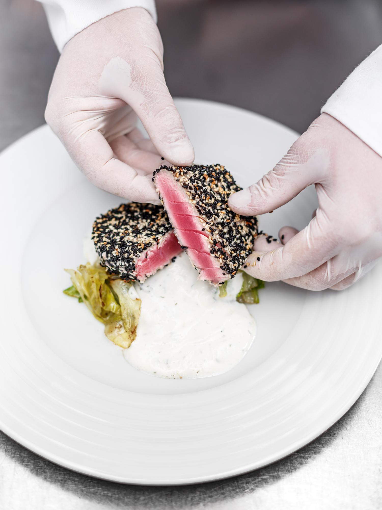 Instructor plating a futuristic dish with molecular elements